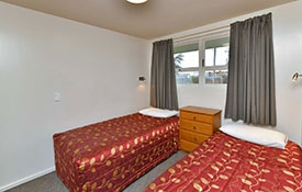 two-bedroom unit with queen-size bed in main room and twin beds in second room